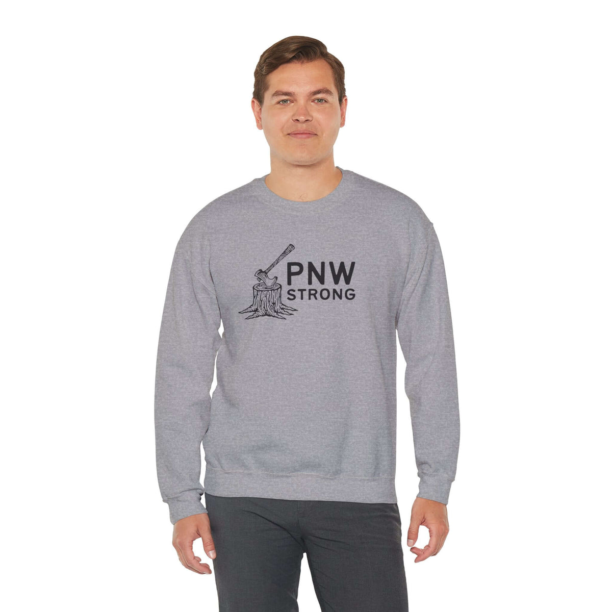 PNW Strong Crewneck Sweatshirt worn by a man, featuring an axe-in-stump design and a rugged style.