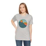 Woman wearing Pacific Peaks Modern Circle Soft Tee with mountain scene graphic, showcasing Pacific Northwest style.