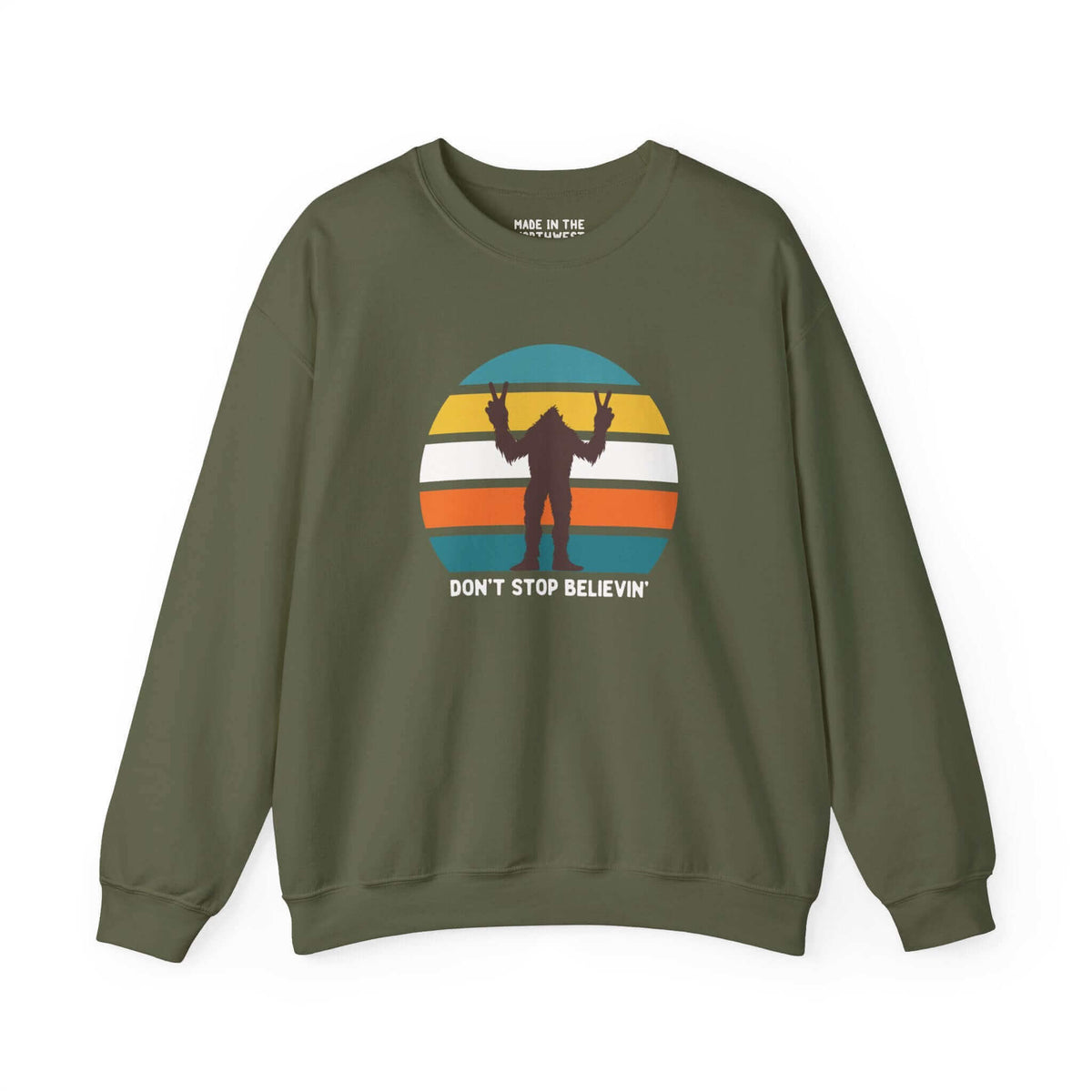 Green Bigfoot sweatshirt with "Don't Stop Believin'" text and sasquatch graphic against colorful striped background.