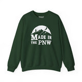 Made in the PNW sweatshirt featuring a mountain graphic on a green crewneck sweater.