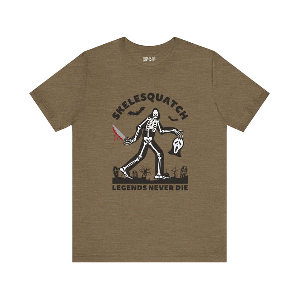 Skelesquatch Halloween tee featuring skeleton sasquatch with knife and mask, perfect for cryptid and horror fans.