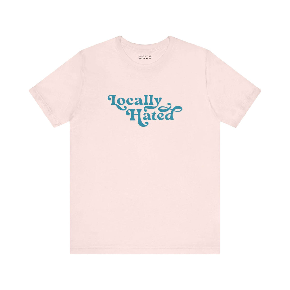 "Locally Hated Soft Tee in beige with bold cursive text, Pacific Northwest inspired, stylish statement shirt for the unapologetic."