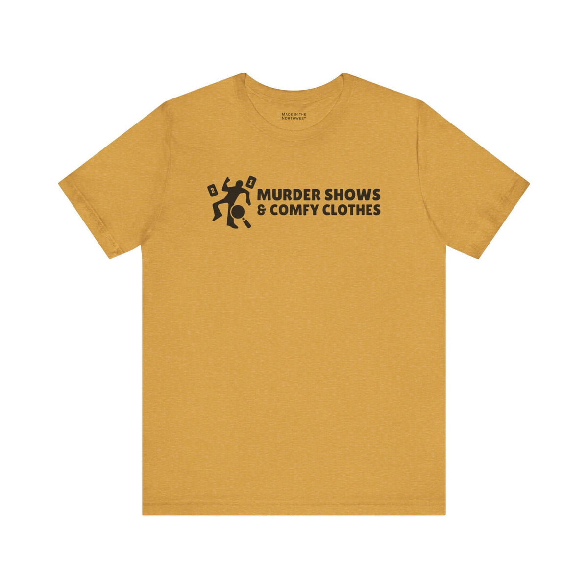 Murder Shows & Comfy Clothes T Shirt in mustard color with playful graphic and bold text.