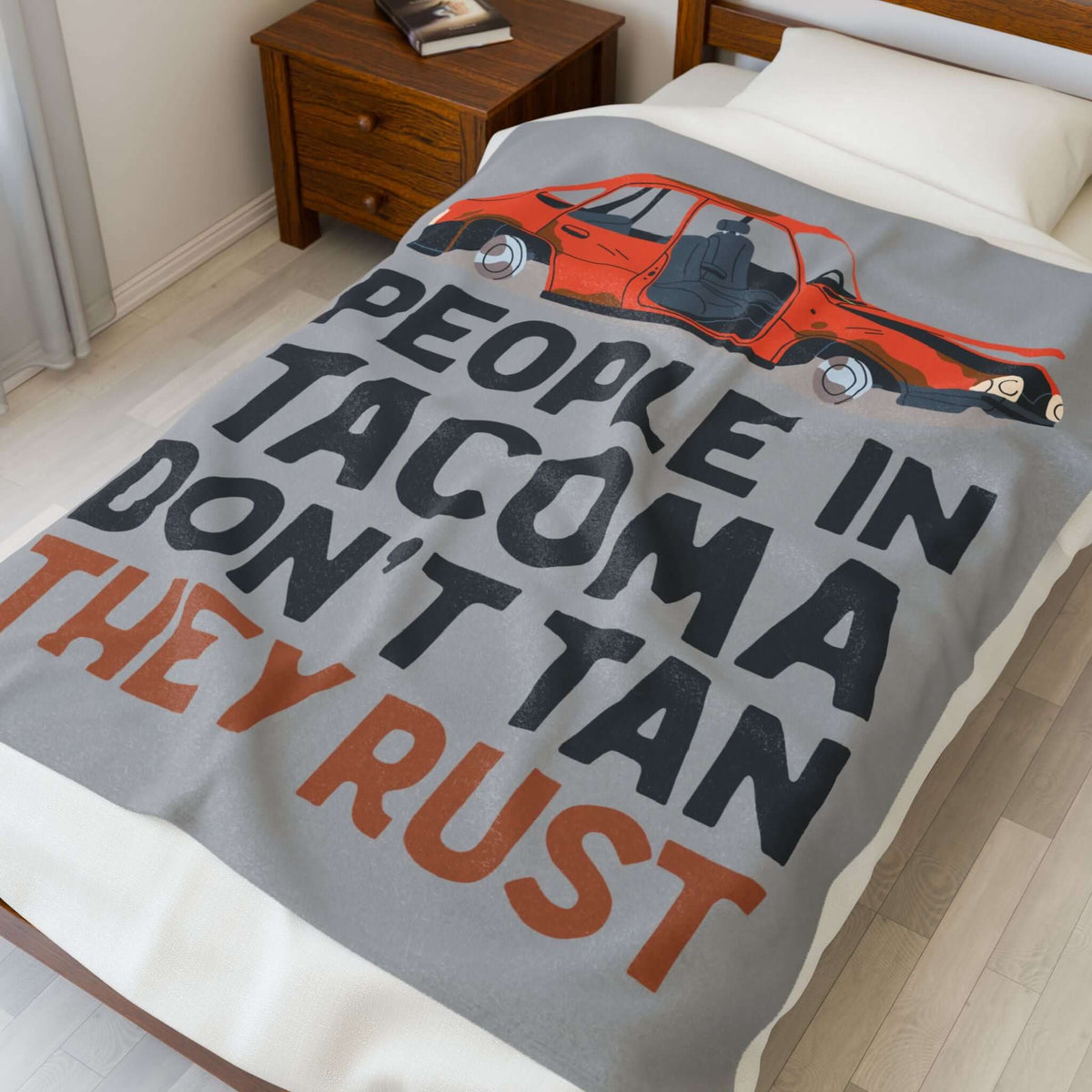 People in Tacoma Don't Tan They Rust Lightweight Cozy Blanket on a bed with a weathered car design.