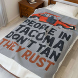People in Tacoma Don't Tan They Rust Lightweight Cozy Blanket on a bed with a weathered car design.