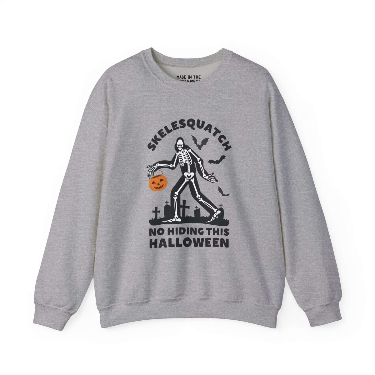 Gray sweatshirt featuring Skelesquatch in a graveyard with a pumpkin bucket, text reads "No Hiding This Halloween". Perfect spooky attire.