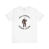 Bigfoot Halloween tee featuring a creature in a mask holding a knife, perfect for spooky season and Sasquatch fans.