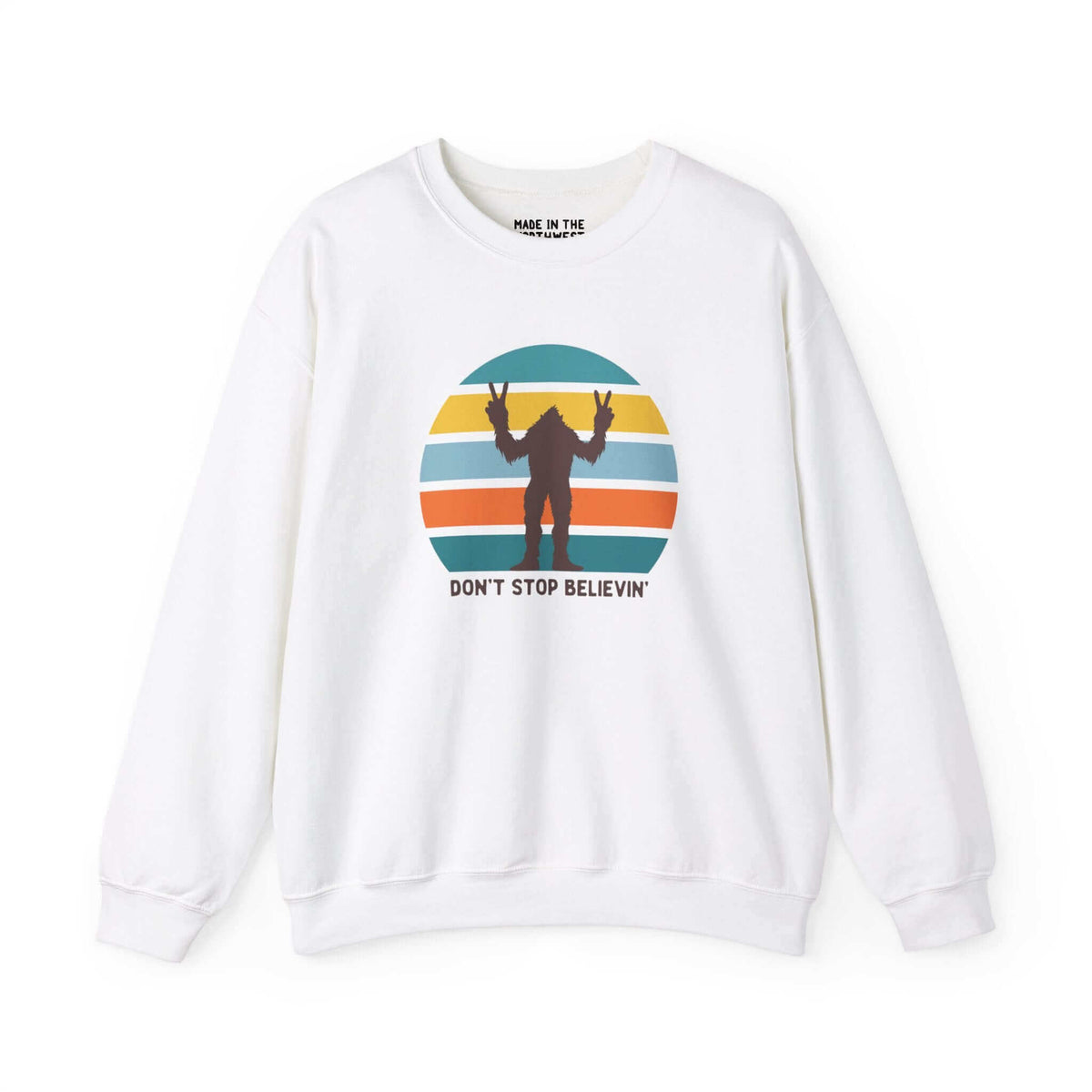 White sweatshirt with Bigfoot silhouette and "Don't Stop Believin'" text on a colorful striped circle design.