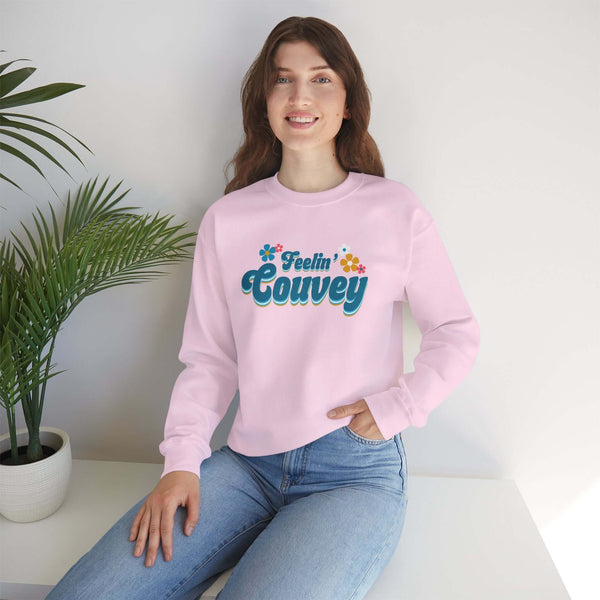 Model wearing pink Feelin' Couvey retro sweatshirt with floral design, showcasing Vancouver's vibrant spirit.