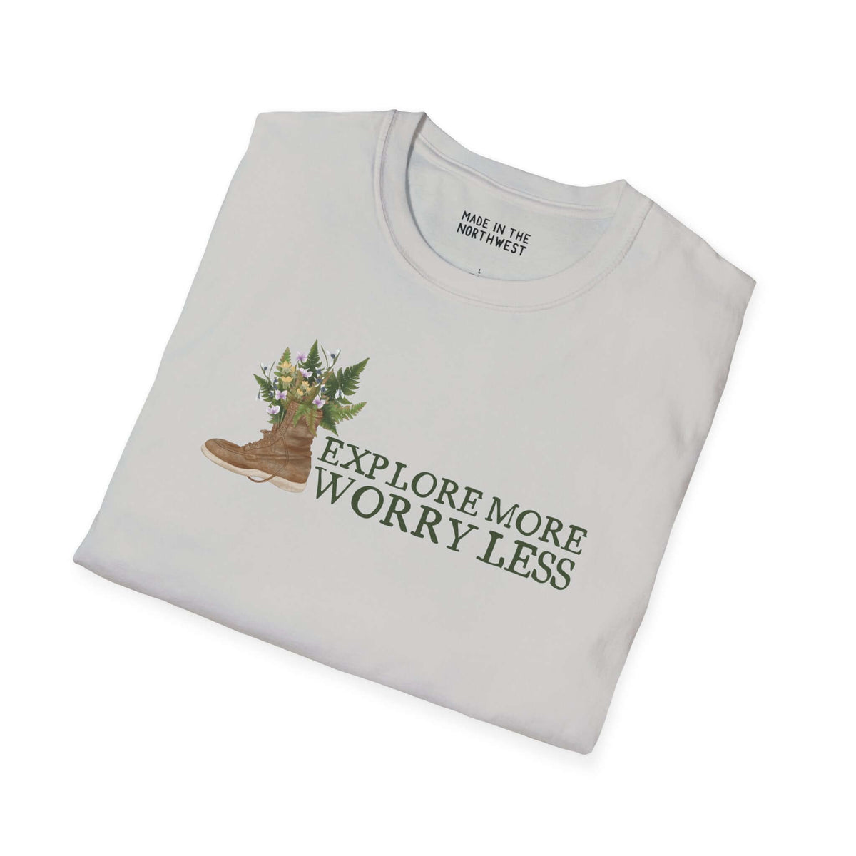 Unisex softstyle t-shirt featuring watercolor hiking boot design with ferns and flowers, saying 'Explore More Worry Less'.