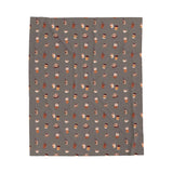 The Daily Grind Coffee Lovers Lightweight Cozy Blanket featuring playful coffee designs in warm colors.
