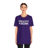 Home is in Tacoma tee worn by a model, showcasing Tacoma pride with a purple shirt design.