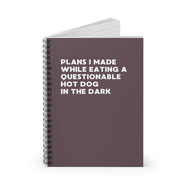 Spiral notebook with quirky title about making plans while eating a questionable hot dog in the dark.
