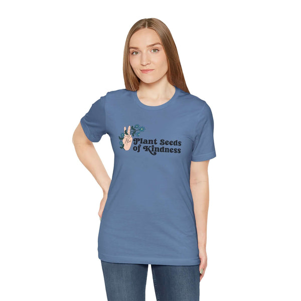 Premium soft tee featuring 'Plant Seeds of Kindness' design with a peace sign and flowers, perfect for spreading positivity.