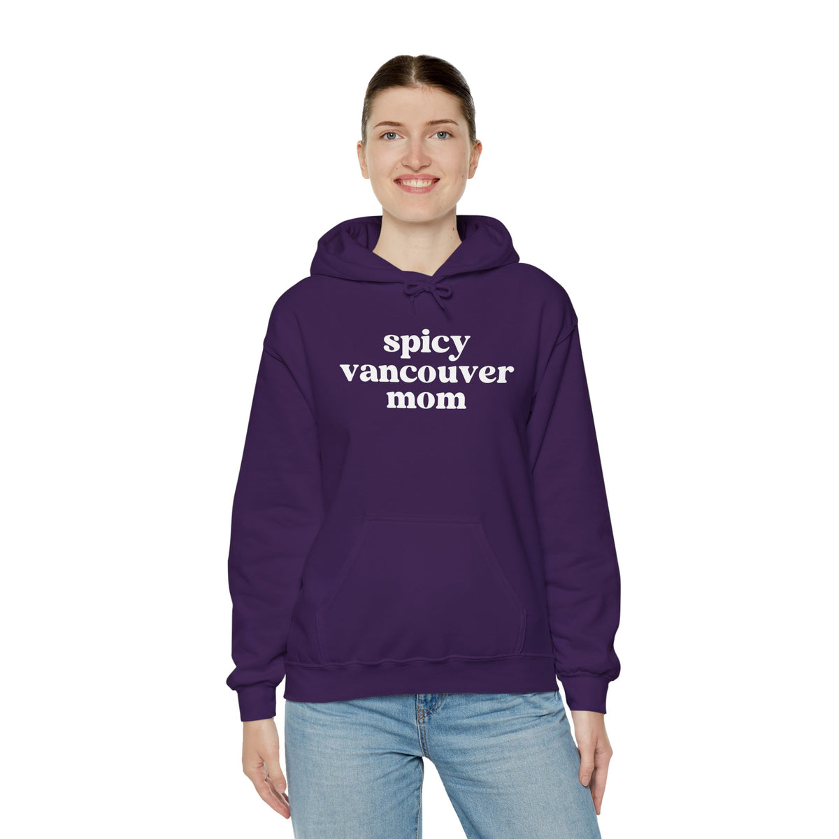 Model wearing Spicy Vancouver Mom cozy hoodie, showcasing bold text on a purple background for a trendy look.