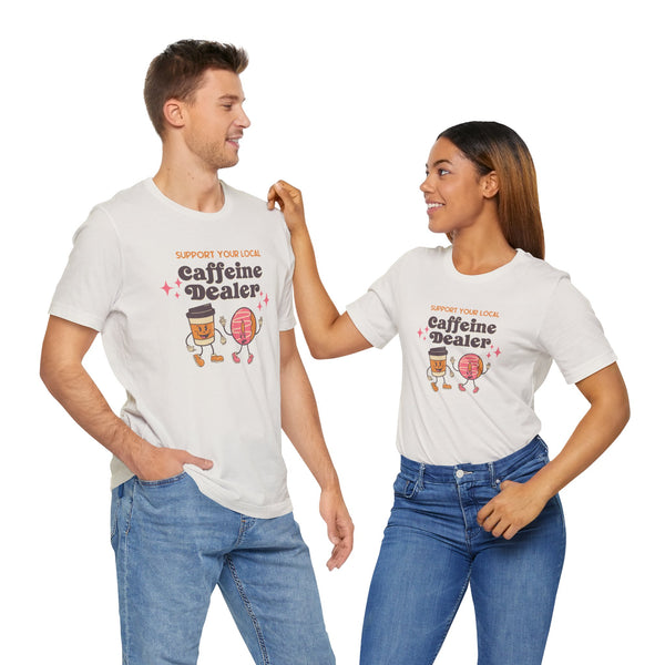Couple wearing 'Support Your Local Caffeine Dealer' coffee-themed tee, featuring playful graphics and vibrant colors.