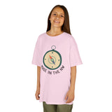 Child wearing a pink t-shirt featuring a compass design and 'Made in the NW' text, showcasing Pacific Northwest pride.