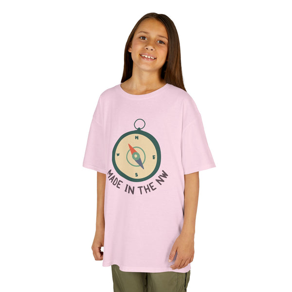 Child wearing a pink t-shirt featuring a compass design and 'Made in the NW' text, showcasing Pacific Northwest pride.