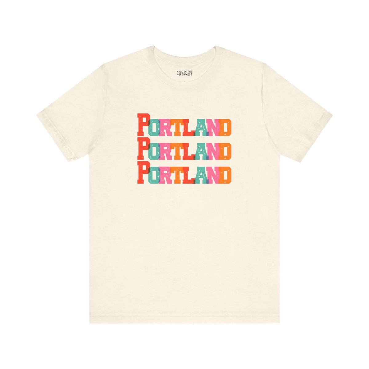 Bold Portland Trio Soft Tee with colorful block-letter design, celebrating Rose City style on a cream background.