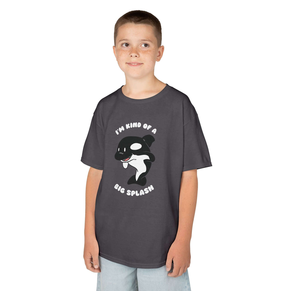 Kid wearing a dark gray tee with playful orca design and slogan 'I'm Kind of a Big Splash'.