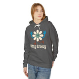 Stay Groovy hoodie featuring a smiling daisy and peace signs, perfect for a cozy, retro vibe.