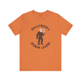 Halloween's Hidden Legend Bigfoot tee featuring Sasquatch dressed as Jason with knife on orange shirt.