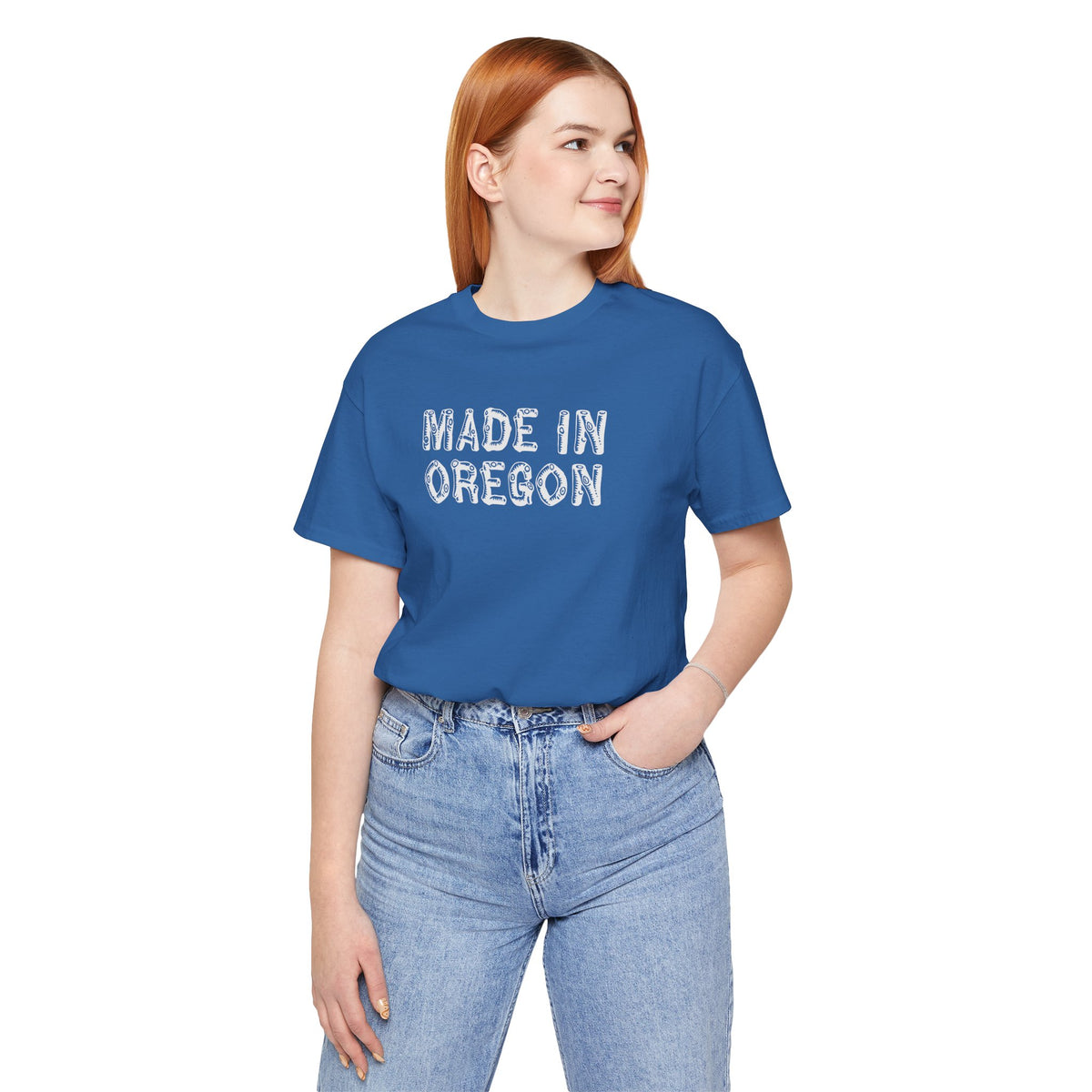 Woman wearing a blue Made in Oregon log font tee, embodying Pacific Northwest outdoor pride.