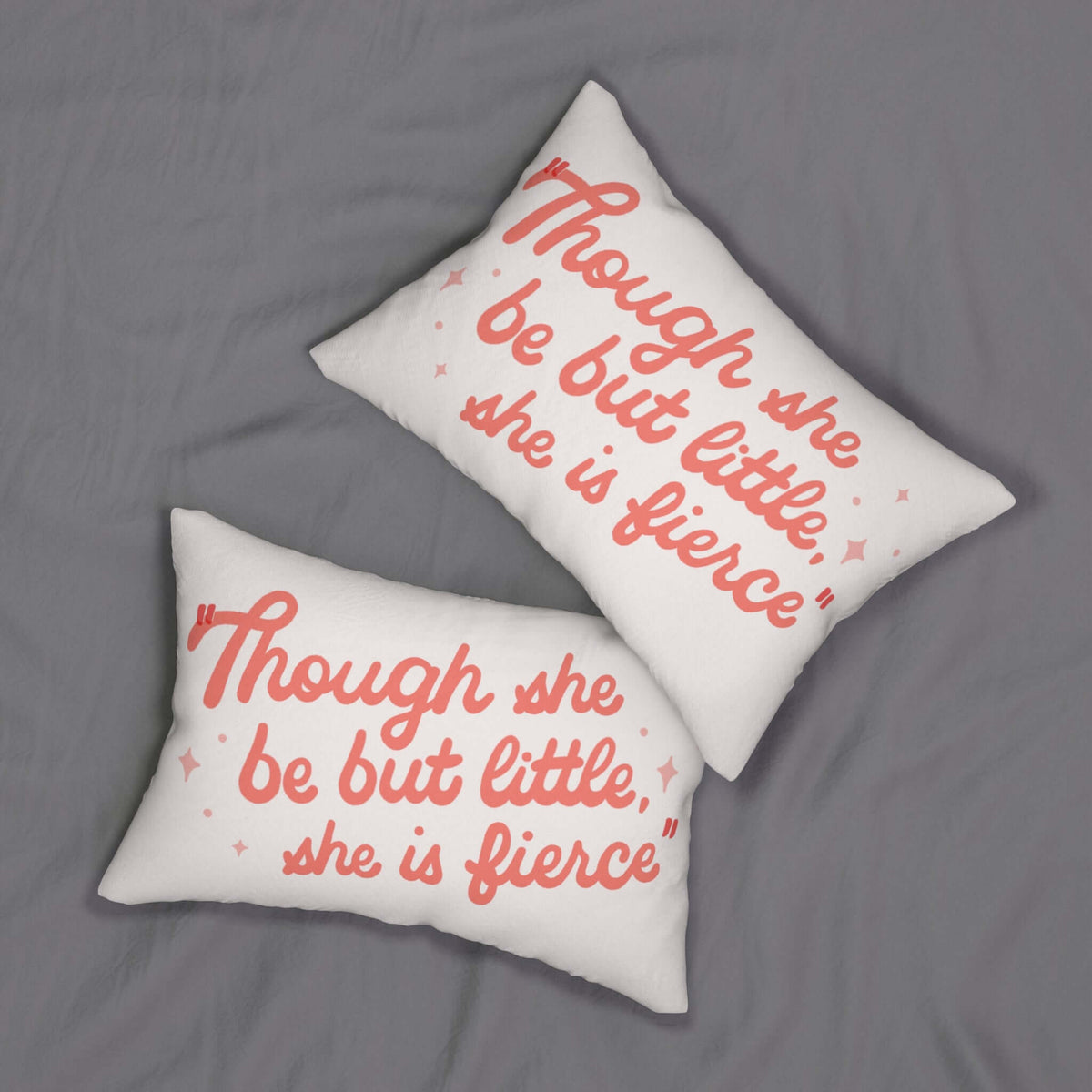 Though She Be But Little She is Fierce Pillow on soft gray backdrop with blush lettering and sparkles.