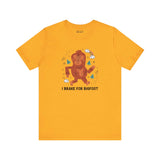 Yellow 'I Brake for Bigfoot' tee featuring a playful Sasquatch graphic, perfect for folklore enthusiasts.