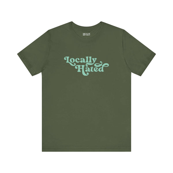 Green "Locally Hated" soft tee with bold cursive font, perfect for those who embrace being notorious in the Pacific Northwest.