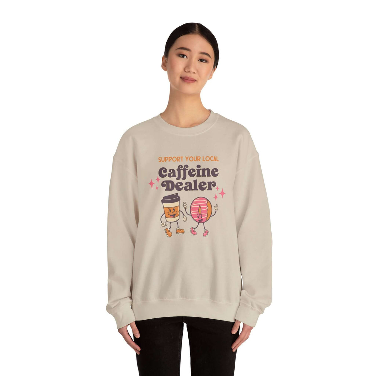 Person wearing "Support Your Local Caffeine Dealer" coffee-themed sweatshirt, promoting local coffee shops and community.