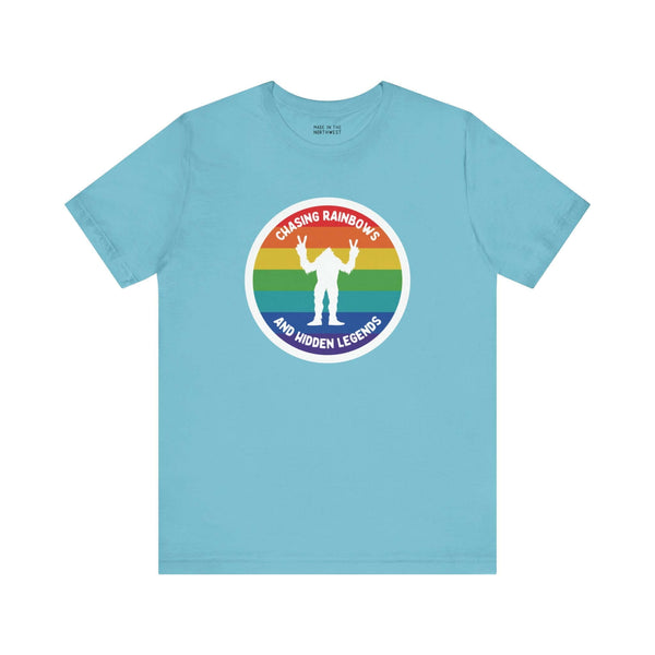 Chasing Rainbows Sasquatch Soft Tee Celebrate your roots with a splash of color and a touch of mystery in our "Hometown Pride" tee. Featuring a vibrant rainbow circle and a playful Sasquatch graphic, this shirt embodies the unique and spirited vibe of the