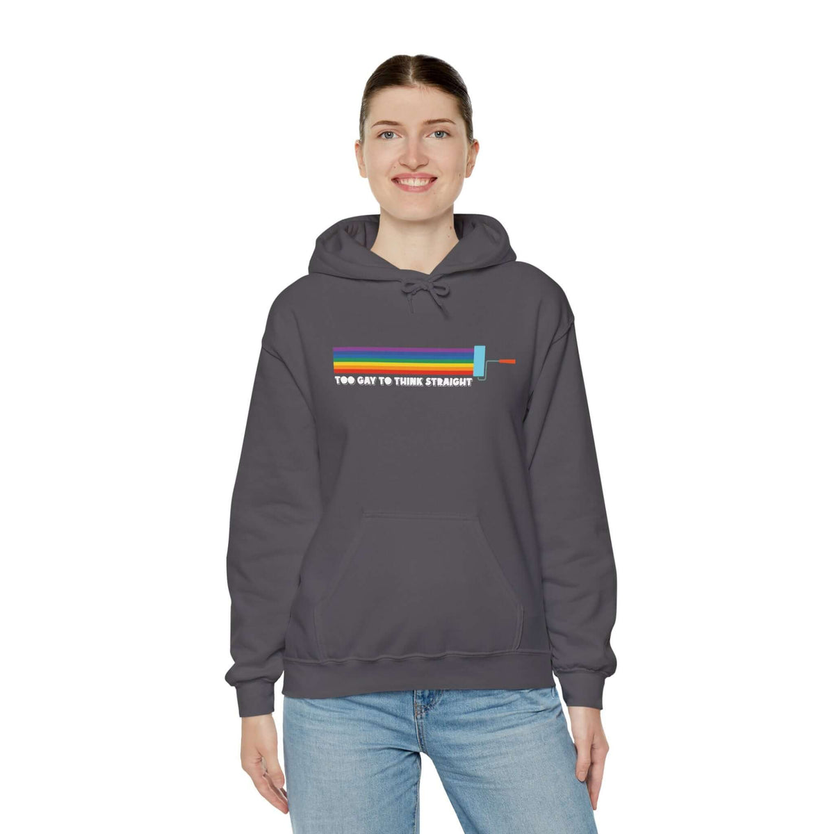 Model wearing a dark gray Too Gay To Think Straight hoodie with rainbow paint roller design, celebrating Pride.