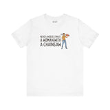 White premium soft tee featuring the quote 'Never Underestimate a Woman with a Chainsaw' and an illustration of a woman with a chainsaw.