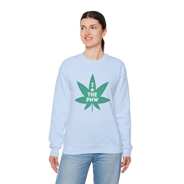Woman wearing a light blue sweatshirt with a green marijuana leaf graphic and text 'I (Weed) the PNW'.
