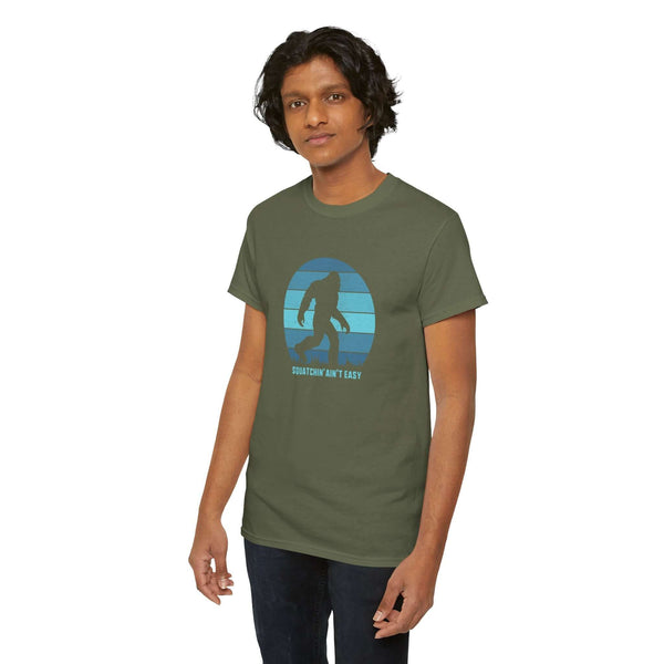 Man wearing Squatchin' Ain't Easy athletic tee featuring Sasquatch design and classic fit.