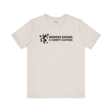 Murder Shows & Comfy Clothes T Shirt featuring a minimalist dark graphic and bold text.