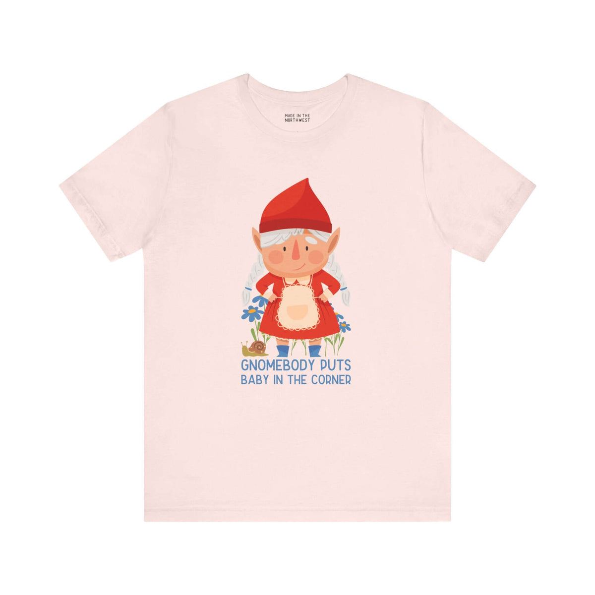 "Whimsical tee with cute female gnome and 'Gnomebody Puts Baby in the Corner' text, perfect for adding humor to your style"