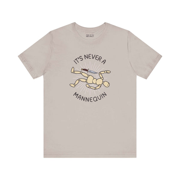 It's Never a Mannequin true crime tee featuring a playful illustration of a mannequin with a knife.