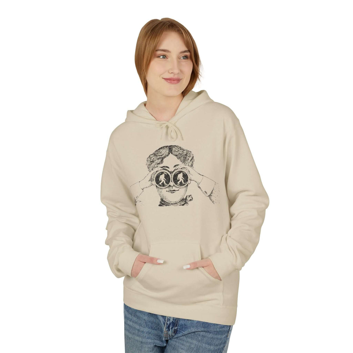 I Spy Bigfoot hoodie worn by a smiling young woman with binoculars illustration, showcasing vintage adventure style.
