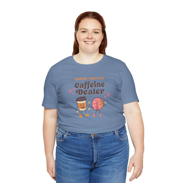 Support Your Local Caffeine Dealer coffee soft tee in blue, featuring playful graphics of coffee cups and pastries.