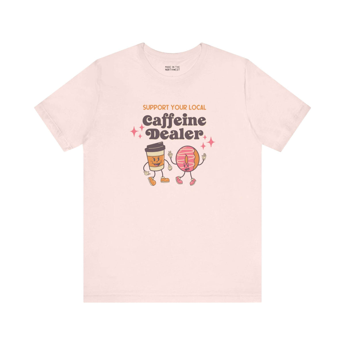 Support Your Local Caffeine Dealer coffee soft tee featuring playful coffee and donut characters on light background.