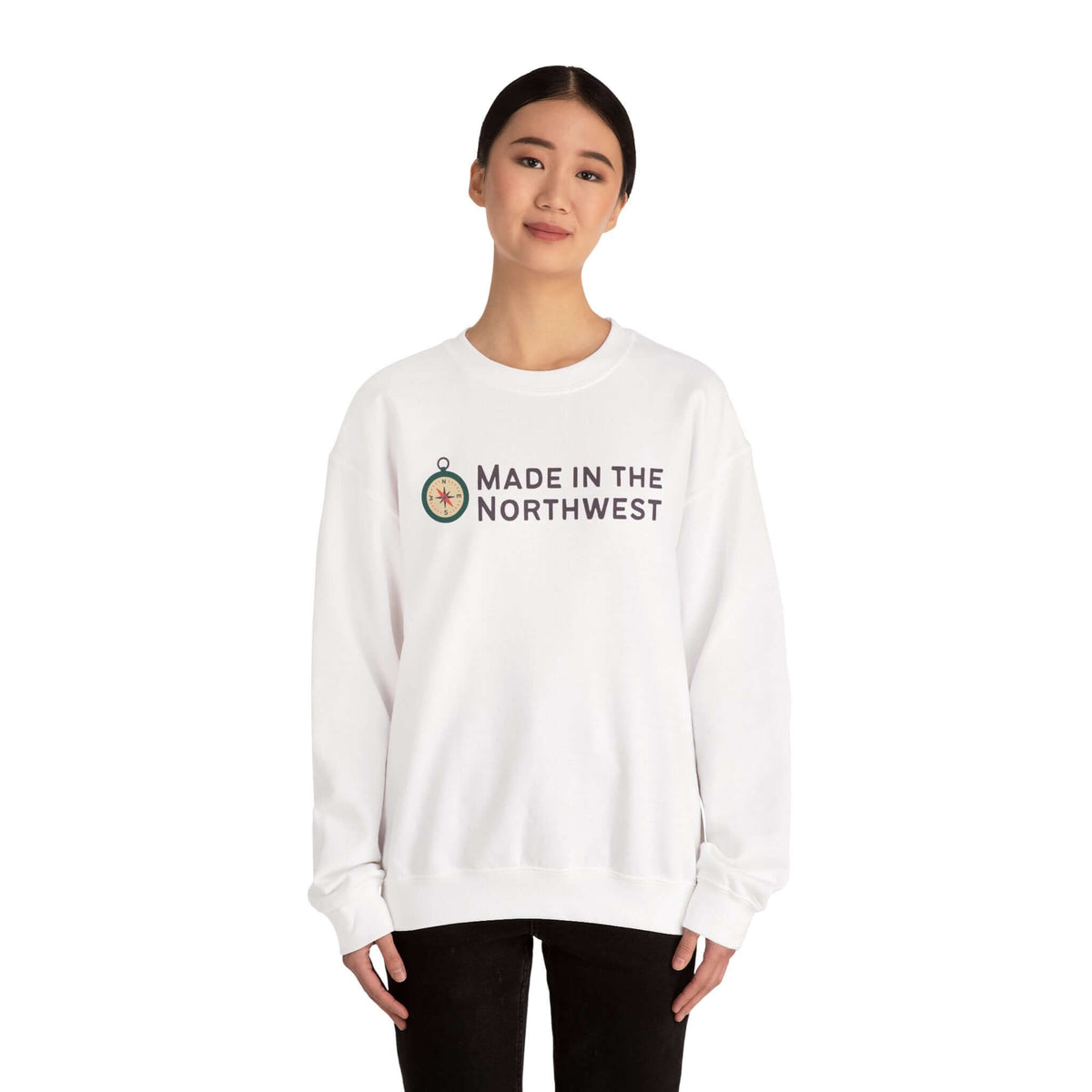 Person wearing a white sweatshirt featuring the phrase Made in the Northwest Sweatshirt with a compass graphic.