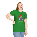 Model wearing a green Love Gnomes No Bounds T-shirt with a gnome holding a rainbow flag, promoting love and inclusivity.
