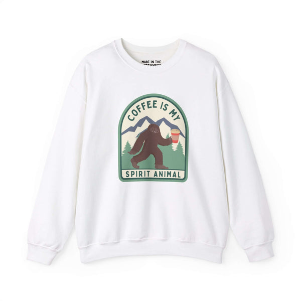 White sweatshirt featuring "Coffee Is My Spirit Animal" with Sasquatch holding a coffee cup, perfect for coffee lovers.