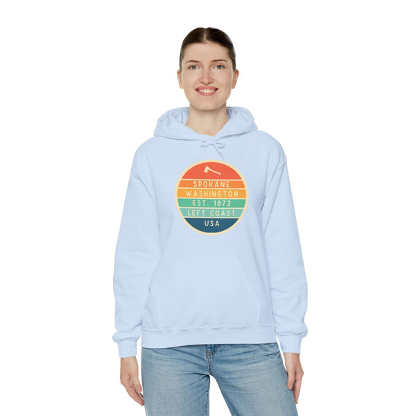 Person wearing Spokane Edition hoodie with Left Coast circular logo, celebrating Pacific Northwest vibes and classic style.