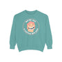 We're All A Little Bit Gay sweatshirt in teal with playful graphic design featuring a smiling face.