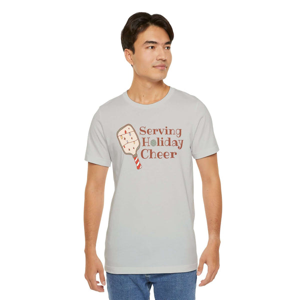 Serving Holiday Cheer Pickleball T Shirt featuring a cheerful paddle and festive design, perfect for holiday matches.
