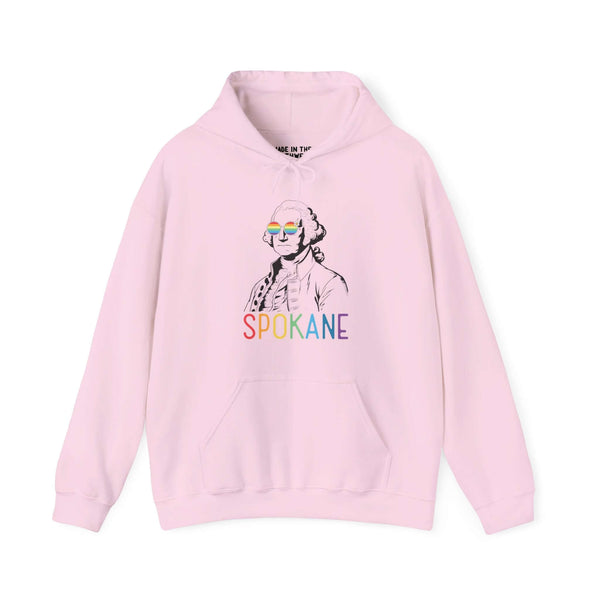 Pink hoodie with rainbow "Spokane" text and line art of George Washington wearing rainbow glasses, celebrating Pride and inclusivity.