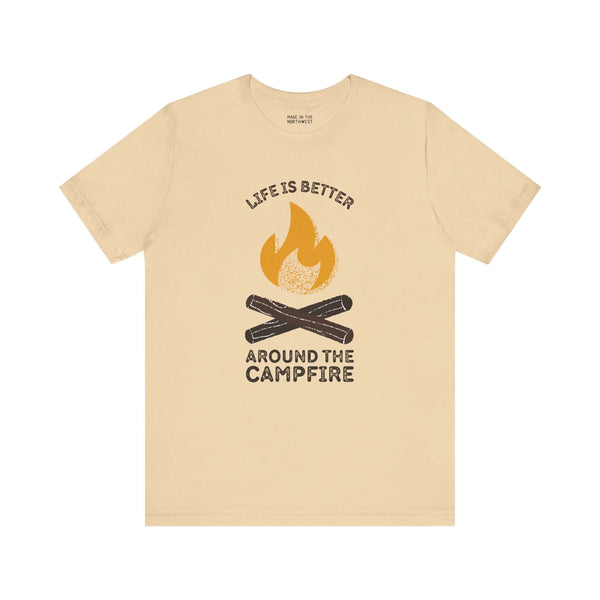 Cozy Campfire Chronicles premium soft tee in beige, featuring campfire design and quote, perfect for outdoor lovers.